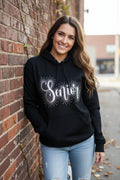 A Black hoodie with Senior embroidered a cross it accented with rhinestones around the word.  
