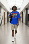 Man wearing a blue t-shirt with a message of freedom and equality, holding a bag.